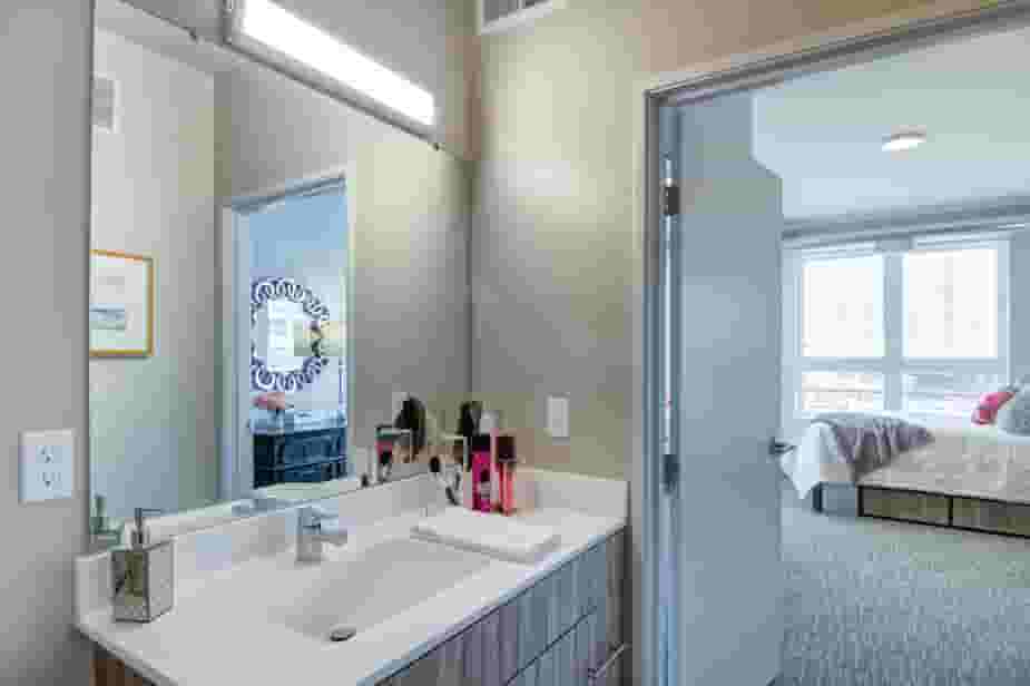 Large bathroom next to bedroom with natrual light